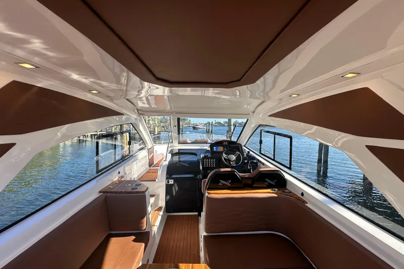 Slide: The Image of Interior of 2025 NX Boats 370, featuring luxurious seating and modern helm design. - 18