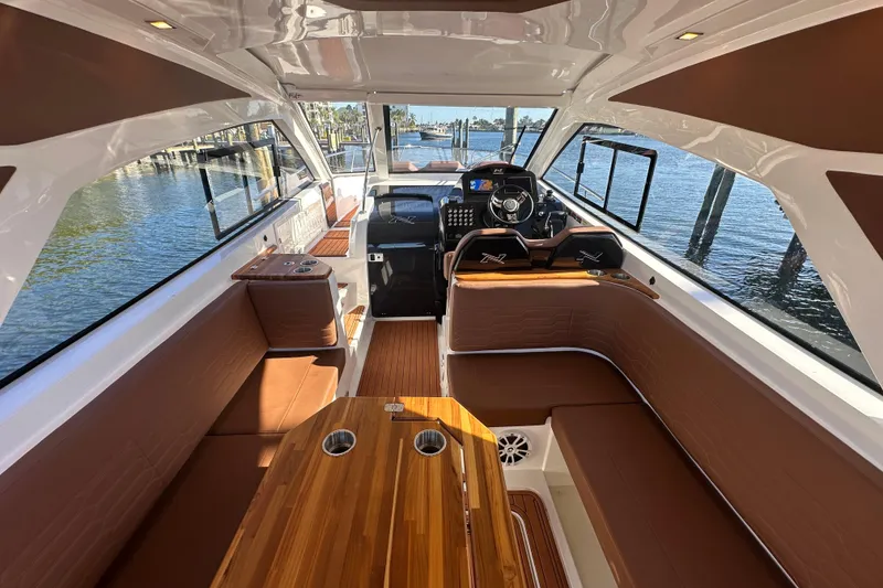Slide: The Image of Luxurious interior of 2025 NX Boats 370, featuring elegant seating and modern helm. - 19