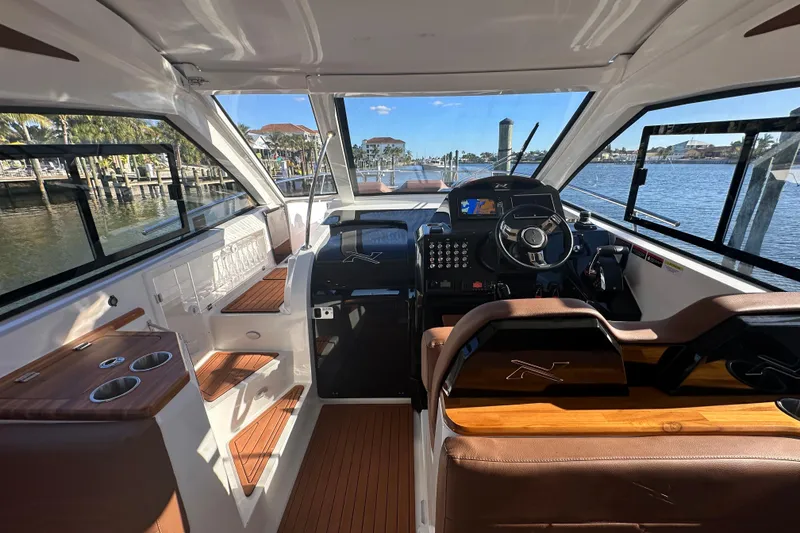 Slide: The Image of Interior of 2025 NX Boats 370, featuring modern helm and luxurious seating. - 22