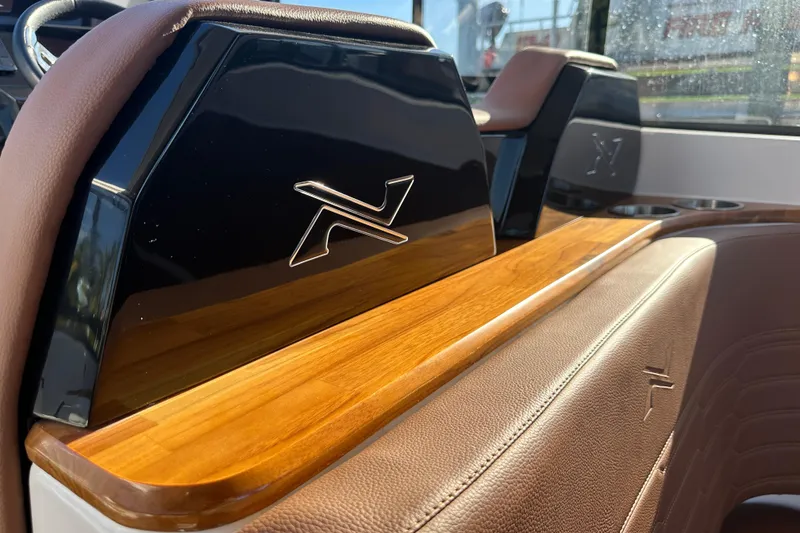 Slide: The Image of Interior of 2025 NX Boats 370, featuring luxurious leather and wood accents. - 25