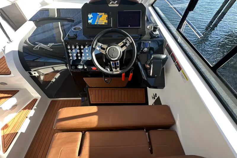 Slide: The Image of 2025 NX Boats 370 cockpit with modern controls and leather seating. - 28
