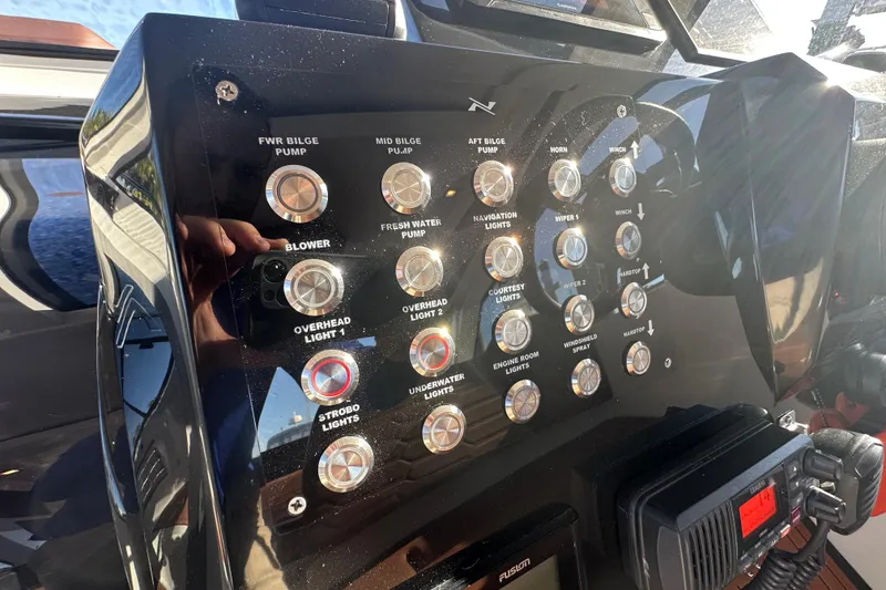 Slide: The Image of Control panel of 2025 NX Boats 370 with various switches and buttons. - 30