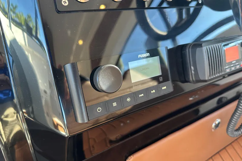 Slide: The Image of Control panel of 2025 NX Boats 370 featuring Fusion audio system. - 31