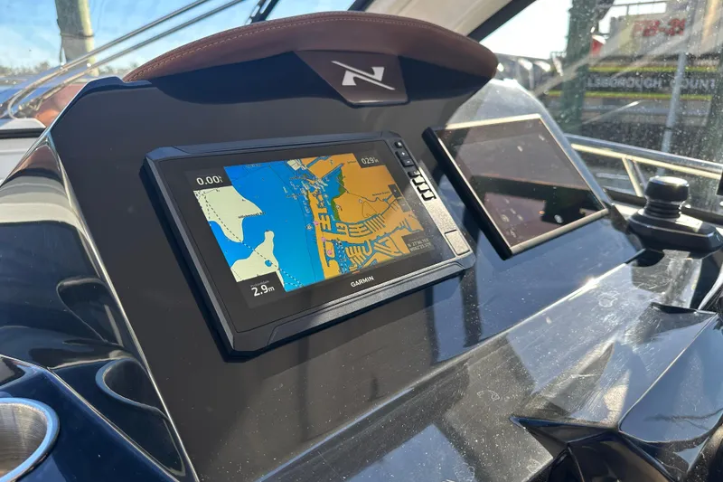 Slide: The Image of 2025 NX Boats 370 dashboard with Garmin navigation display. - 34