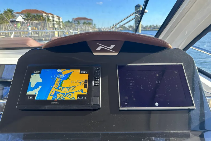 Slide: The Image of Dashboard of 2025 NX Boats 370 with navigation and control screens. - 35