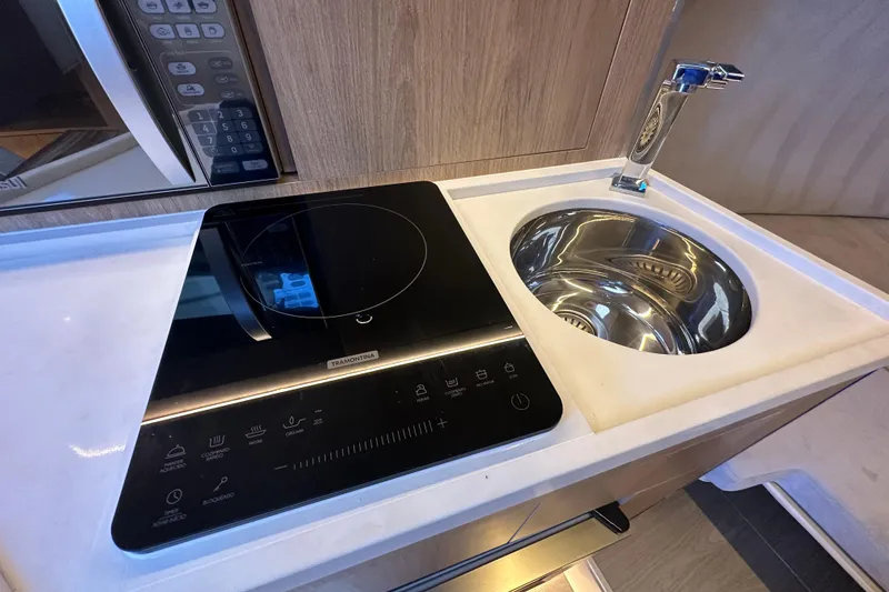 Slide: The Image of Modern kitchen area in 2025 NX Boats 370 with induction cooktop and sink. - 50