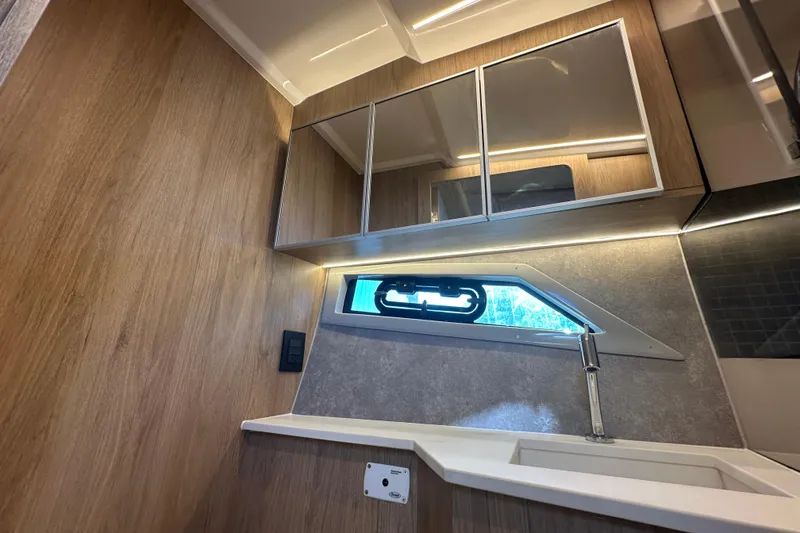 Slide: The Image of Modern interior of 2025 NX Boats 370 with wood paneling and sleek cabinetry. - 53