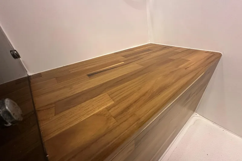 Slide: The Image of Wooden interior detail of 2025 NX Boats 370, showcasing sleek design and craftsmanship. - 60