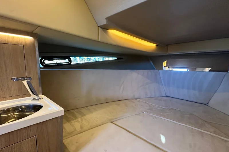 Slide: The Image of Luxurious interior cabin of 2025 NX Boats 370 with modern sink and ambient lighting. - 61