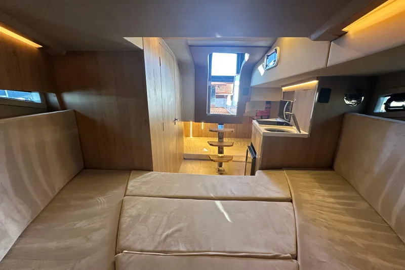 Slide: The Image of Luxurious interior of 2025 NX Boats 370, featuring modern kitchen and cozy seating area. - 66
