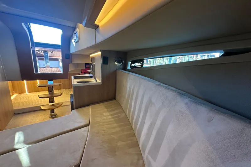 Slide: The Image of Luxurious interior of 2025 NX Boats 370, featuring modern seating and sleek design elements. - 67