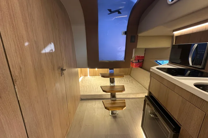 Slide: The Image of Interior of 2025 NX Boats 370, featuring modern kitchen and wooden accents. - 69