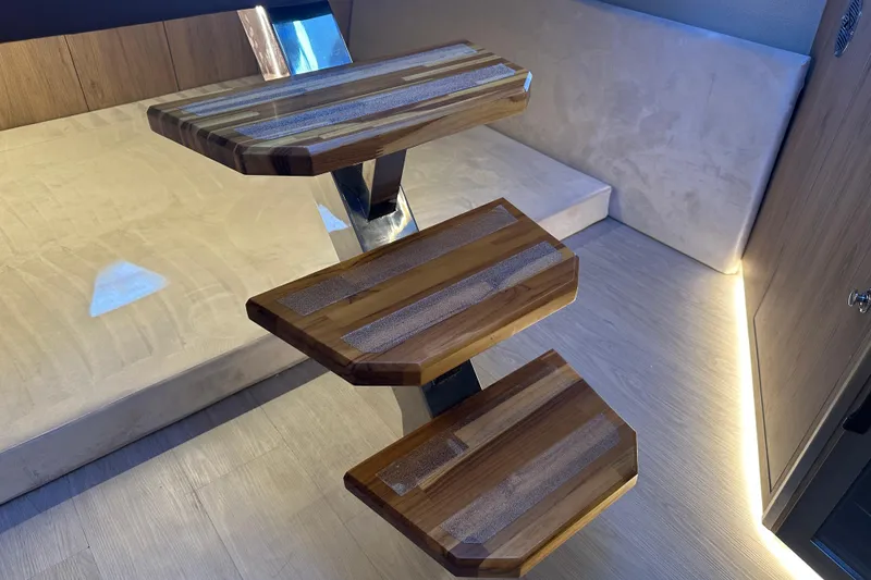 Slide: The Image of Wooden staircase inside 2025 NX Boats 370, featuring modern design and ambient lighting. - 72