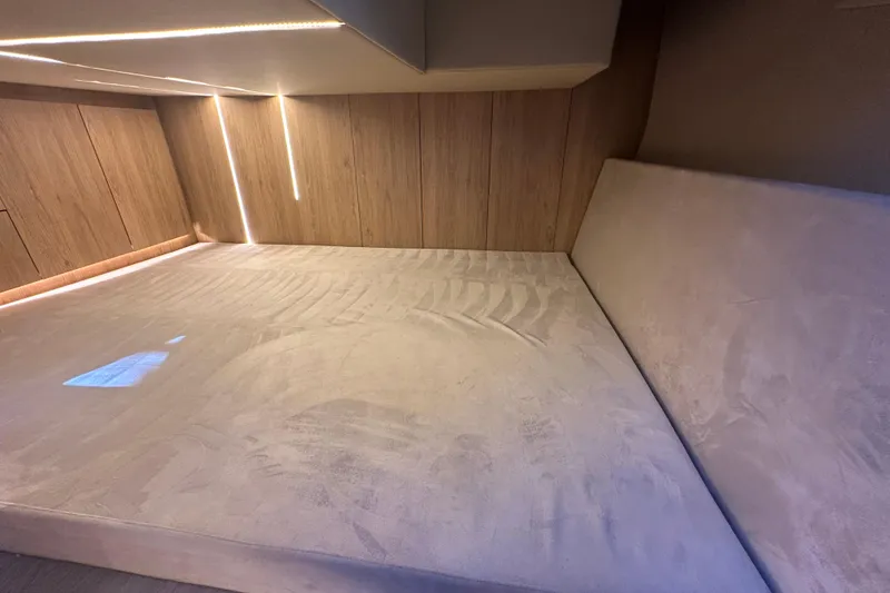 Slide: The Image of Luxurious interior cabin of 2025 NX Boats 370 with modern lighting and plush bedding. - 74