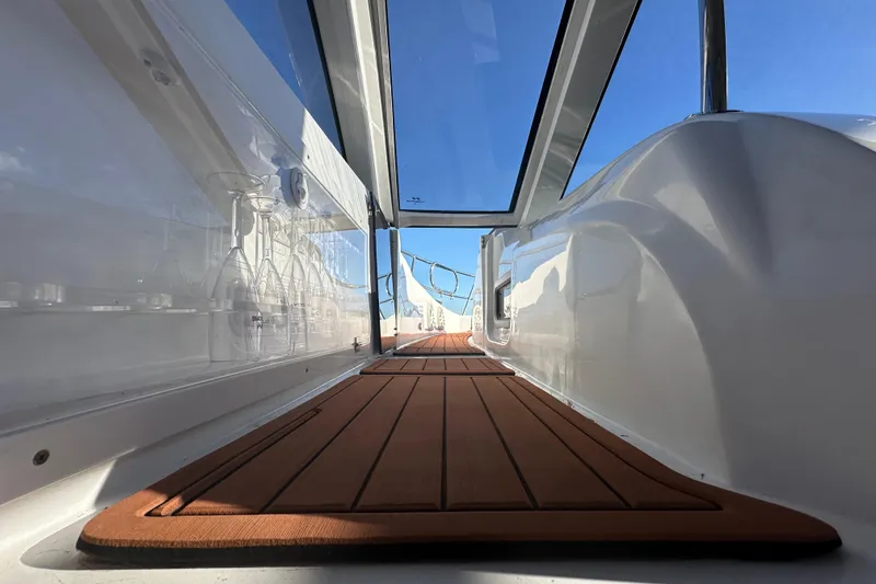 Slide: The Image of Interior view of 2025 NX Boats 370, featuring sleek design and wooden flooring. - 81