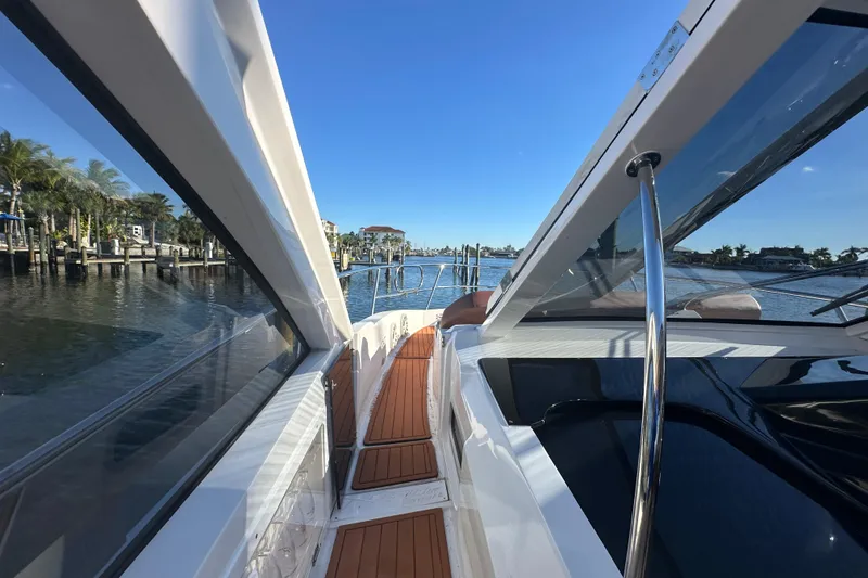 Slide: The Image of 2025 NX Boats 370 yacht with sleek design and wooden deck, cruising on a sunny day. - 83