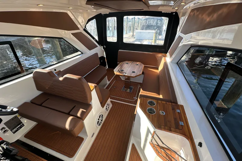 Slide: The Image of Interior of 2025 NX Boats 370, featuring elegant seating and wooden accents. - 99