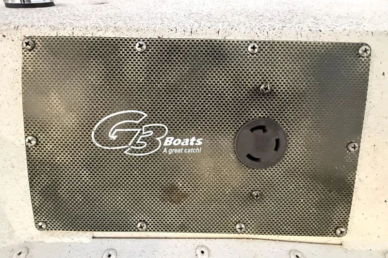 Slide: The Image of 2019 G3 Bay 22 DLX boat on trailer at sunset by the water. - 12