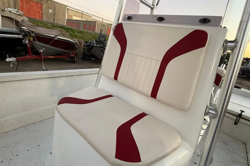 Slide: The Image of 2019 G3 Bay 22 DLX boat console with steering wheel and controls, docked outdoors. - 17