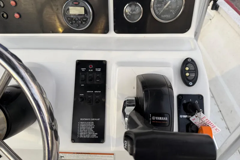 Slide: The Image of 2019 G3 Bay 22 DLX boat with console, parked near waterfront at sunset. - 18