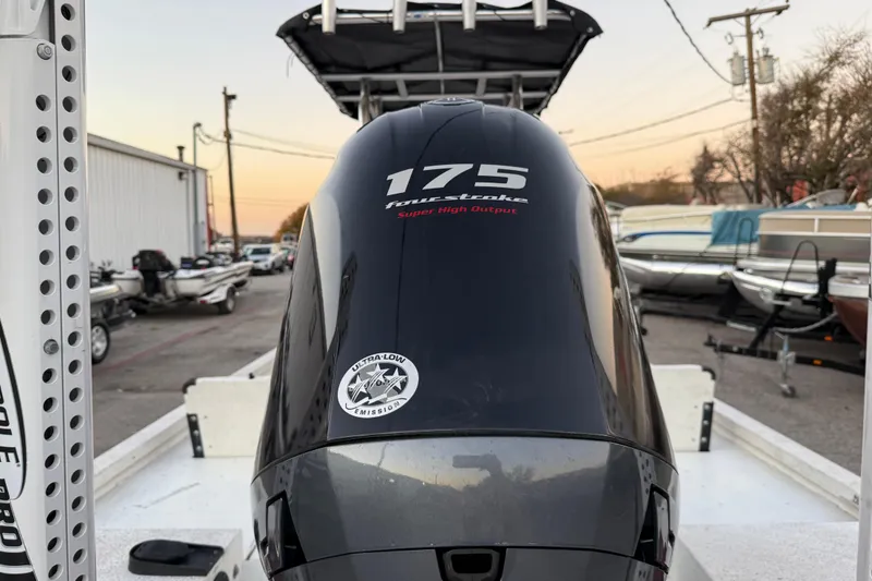 Slide: The Image of 2019 G3 Bay 22 DLX boat on trailer at sunset by the water. - 23