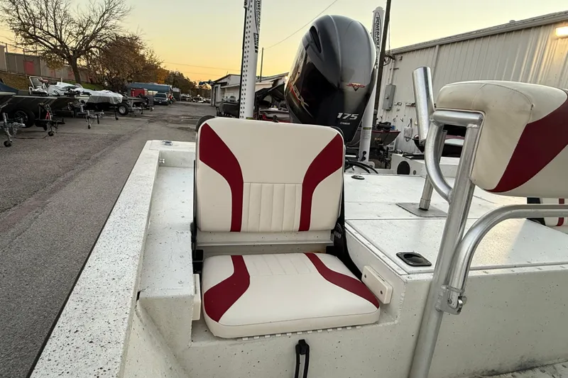 Slide: The Image of 2019 G3 Bay 22 DLX boat with red and white seating, docked by the water. - 25