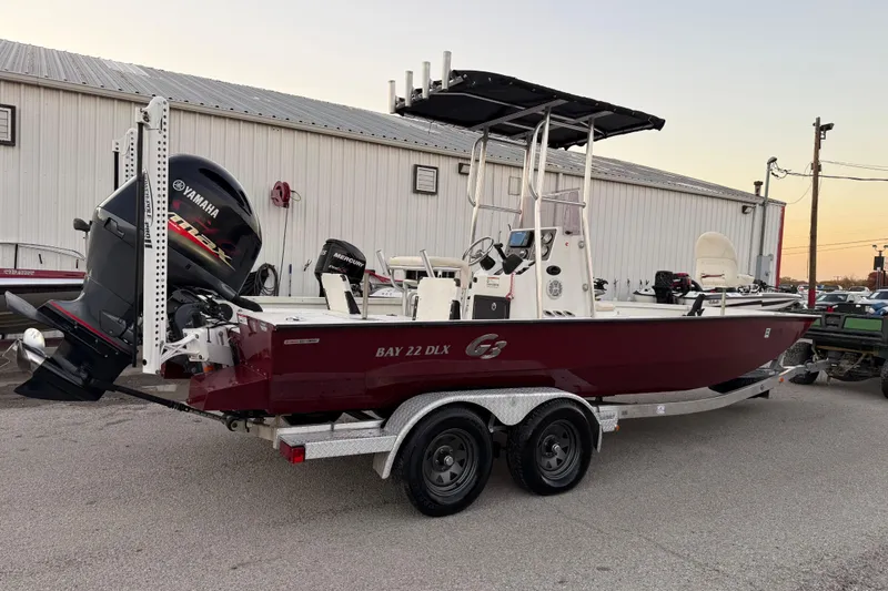 Slide: The Image of 2019 G3 Bay 22 DLX boat with red exterior and metallic lettering. - 31
