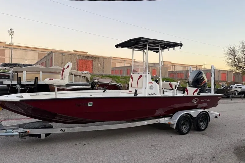 Slide: The Image of 2019 G3 Bay 22 DLX boat on trailer at sunset by the water. - 4