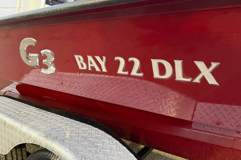 Slide: The Image of 2019 G3 Bay 22 DLX boat on trailer at sunset by the water. - 5