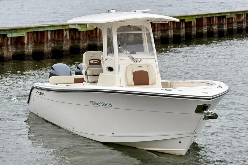 The Image of 2023 Cobia 262 Center Console boat on water, showcasing sleek design and modern features. - 0