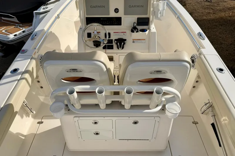 Slide: The Image of 2023 Cobia 262 Center Console boat interior with dual seats and Garmin navigation. - 15