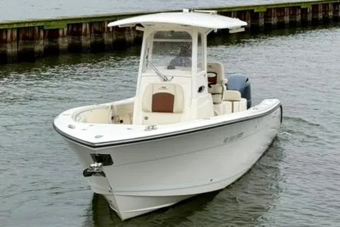 Slide: The Image of 2023 Cobia 262 Center Console boat on water, showcasing sleek design and modern features. - 2