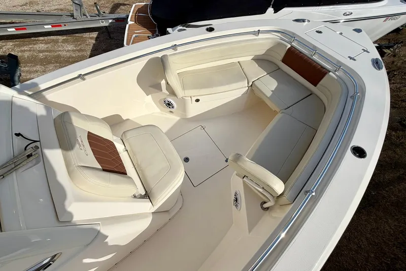 Slide: The Image of 2023 Cobia 262 Center Console boat interior with cushioned seating and stainless steel railings. - 23