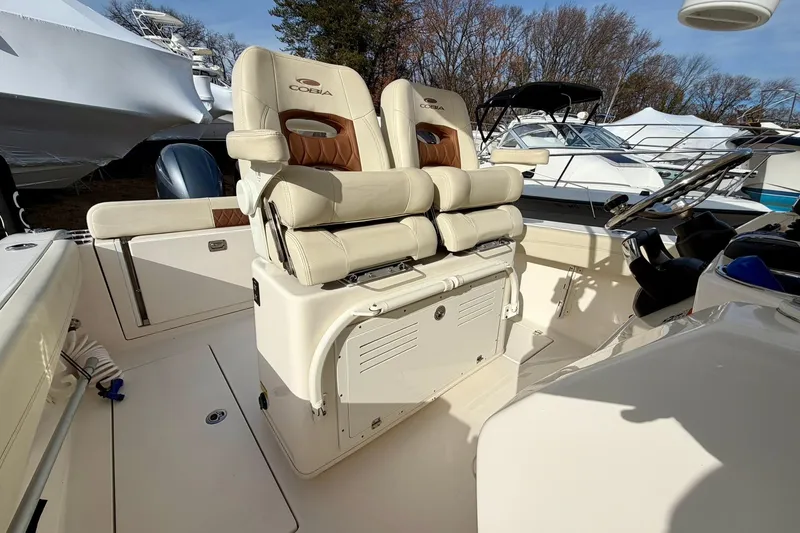 Slide: The Image of 2023 Cobia 262 Center Console boat interior with dual seating and steering console. - 24