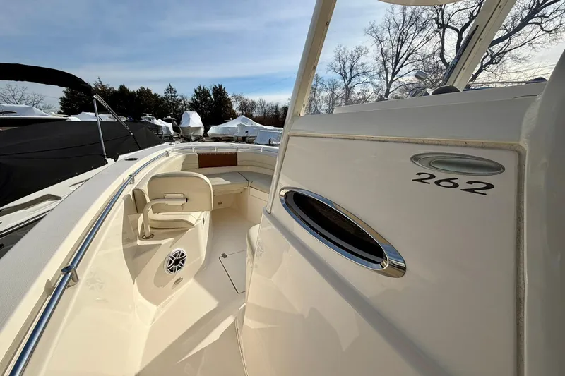 Slide: The Image of 2023 Cobia 262 Center Console boat, showcasing sleek design and spacious seating area. - 26