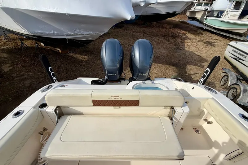 Slide: The Image of 2023 Cobia 262 Center Console boat with dual engines, spacious seating, and sleek design. - 29