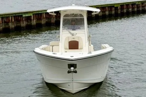 Slide: The Image of 2023 Cobia 262 Center Console boat on water, front view. - 3