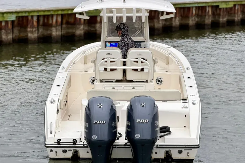 Slide: The Image of 2023 Cobia 262 Center Console boat with dual Yamaha 200 engines on water. - 4