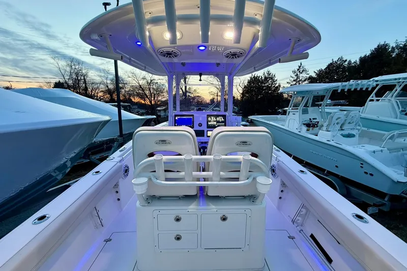 Slide: The Image of 2023 Cobia 262 Center Console boat interior with illuminated dashboard at sunset. - 9