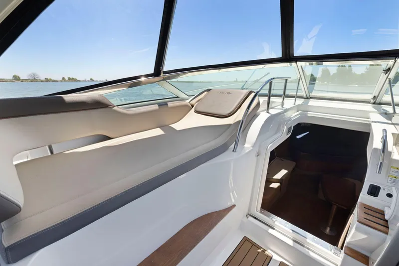 Slide: The Image of 2014 Sea Ray 350 Sundancer boat interior with open cabin and sleek design. - 17