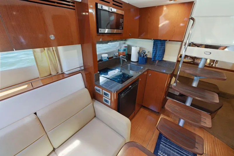 Slide: The Image of Interior of 2014 Sea Ray 350 Sundancer yacht with modern kitchen and seating area. - 24