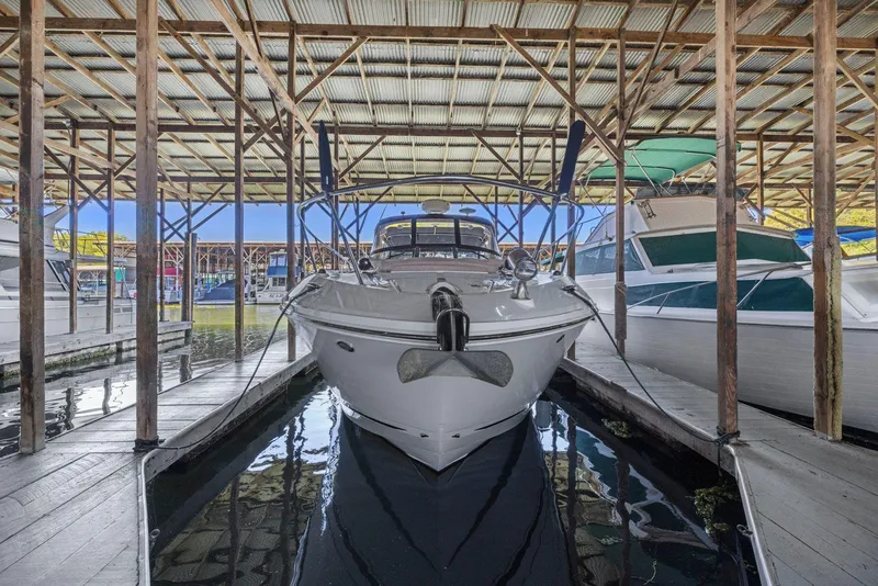 Slide: The Image of 2014 Sea Ray 350 Sundancer docked in a covered marina. - 35