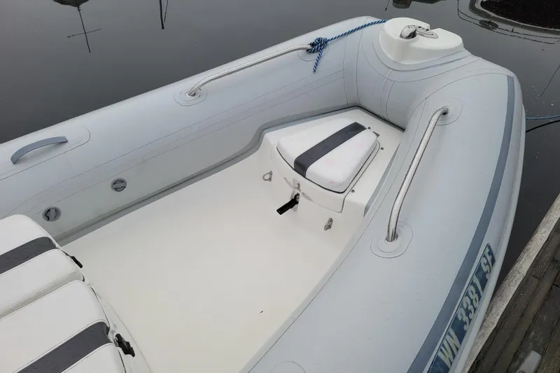 Slide: The Image of 2014 AB Inflatables Oceanus 15 VST boat, white interior, docked on calm water. - 6