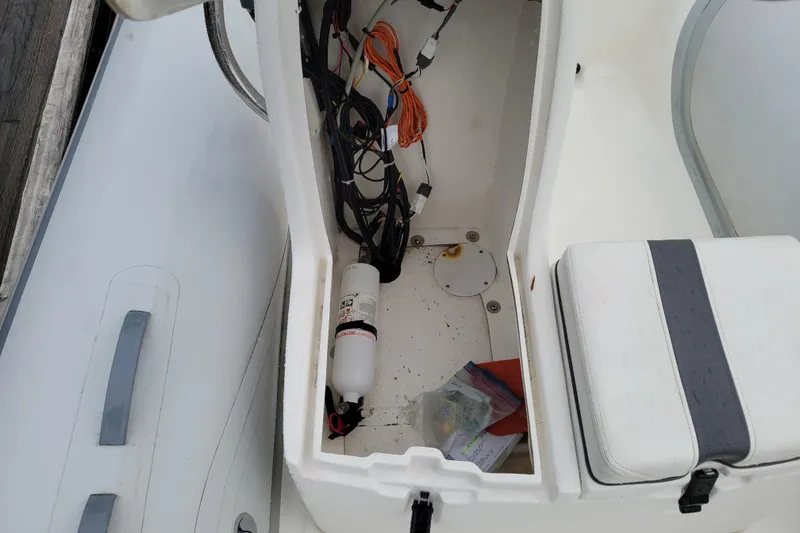 Slide: The Image of 2014 AB Inflatables Oceanus 15 VST boat storage compartment with wiring and fire extinguisher. - 9
