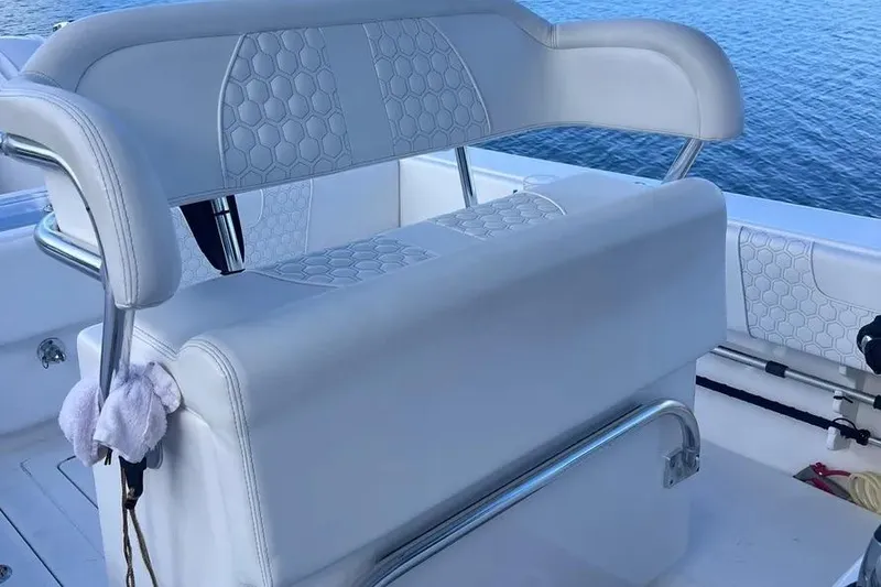 Slide: The Image of 2024 Contender 30 Tournament boat seating with hexagonal pattern, overlooking water. - 16