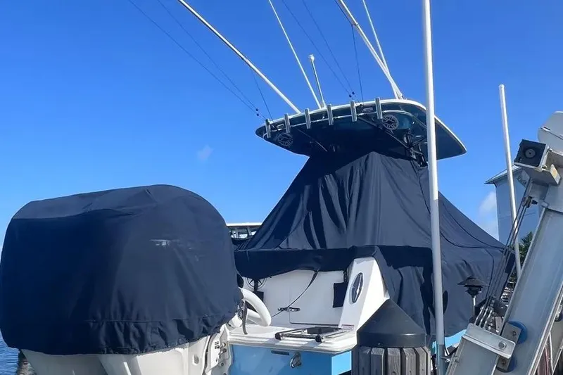 Slide: The Image of 2024 Contender 30 Tournament boat covered at dock, clear blue sky background. - 2