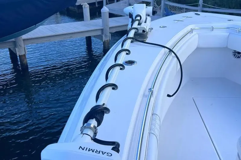 Slide: The Image of 2024 Contender 30 Tournament boat with Garmin equipment docked by the water. - 22