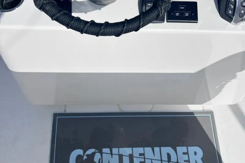 Slide: The Image of 2024 Contender 30 Tournament boat dashboard with steering wheel and controls. - 6