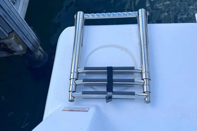 Slide: The Image of Folded stainless steel ladder on 2024 Contender 30 Tournament boat deck. - 9