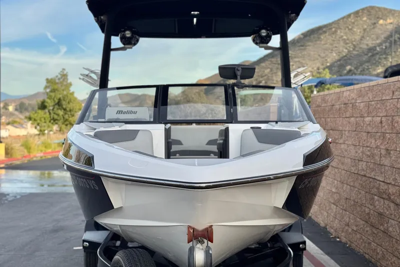 Slide: The Image of 2020 Malibu Wakesetter 22 LSV boat parked with scenic mountain backdrop. - 2